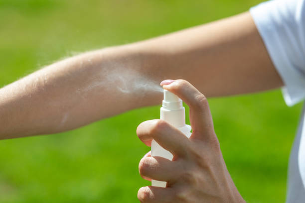 woman spraying mosquito insect repellen woman spraying mosquito insect repellen
